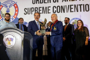 National Commander Dr. Anthony J. Limberakis, who is joined by his family, is presented with the AHEPA Archbishop Iakovos Humanitarian Award by Supreme President E. Chris Kaitson, during the AHEPA Supreme Convention in Philadelphia, PA.