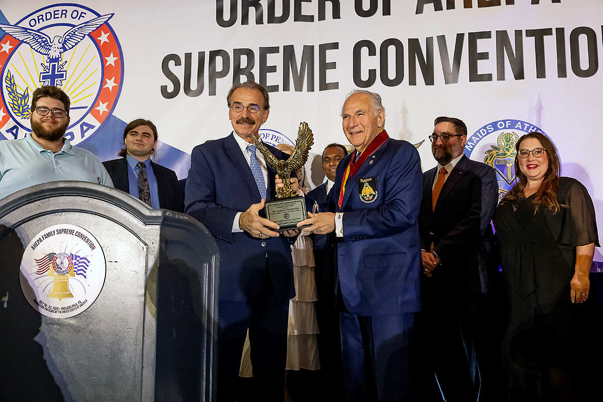 National Commander Dr. Anthony J. Limberakis, who is joined by his family, is presented with the AHEPA Archbishop Iakovos Humanitarian Award by Supreme President E. Chris Kaitson, during the AHEPA Supreme Convention in Philadelphia, PA.
