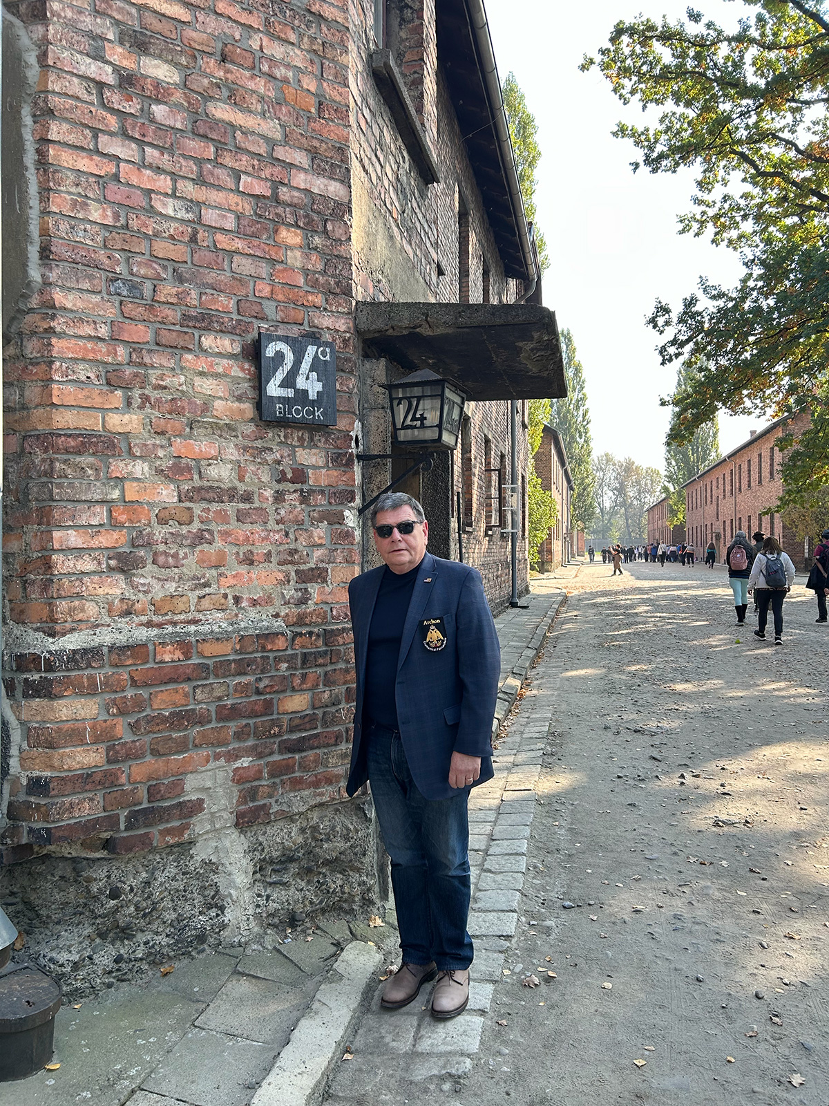 Archon Trakas outside a death camp gate at Auschwitz. A powerful and mournful reminder in perpetuity of the perils of religious persecution.